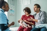 Parents with newborn at doctor office