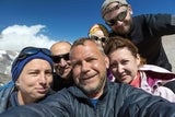 Group of adults taking a selfie outside