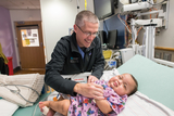 Doctor examines baby.