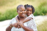 Sickle cell patient smiling with her mother outside