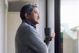 Man looking out of window