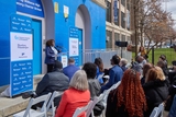 Speaker at an outdoor CHOP event with an audience.