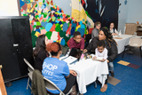 A family sitting at a table with CHOP employees.