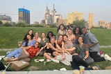 Group of young people smiling on a green lawn