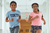 Young boy and girl running down hall