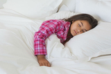 Older female toddler sleeping in bed