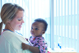 Nurse holding baby.