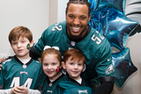 Najee Goode poses with kids at the 8th annual Huddle Up for Autism