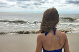 Girl on beach wearing patch