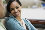 Teen girl driver in car smiling at father