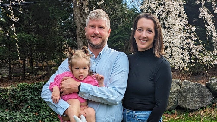 Couple in yard with baby