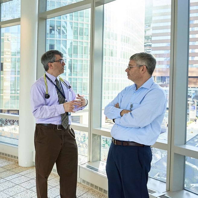 two physiciands discussing treatment in a hallway