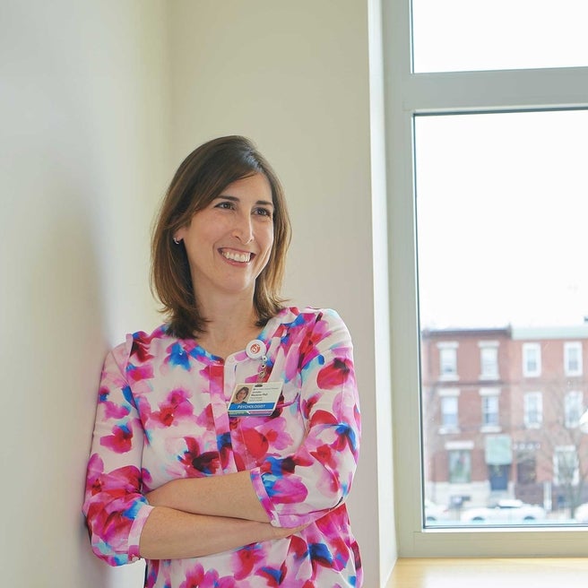 Doctor leaning on a wall by a window