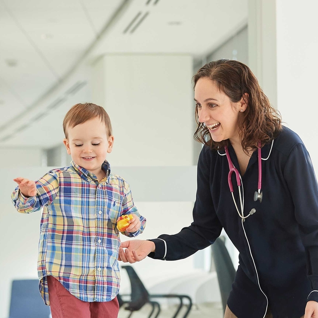 Staff member helping a patient walk