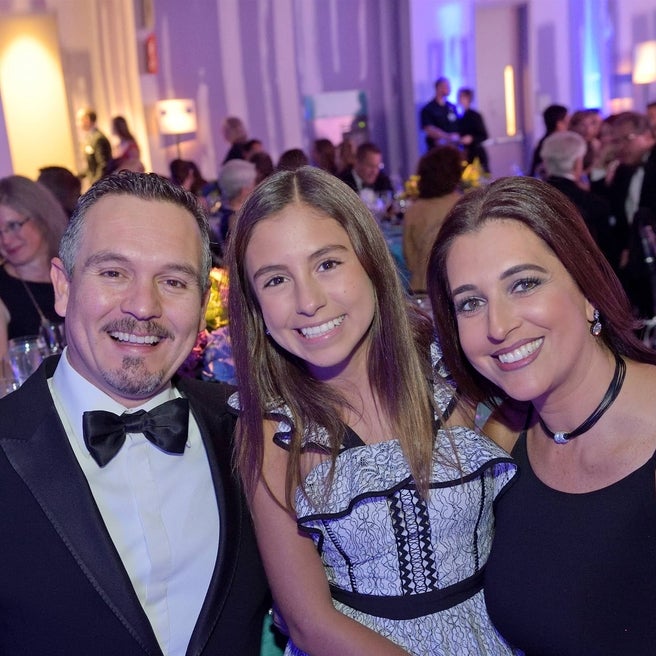 Family smiling together at Carousel Ball event