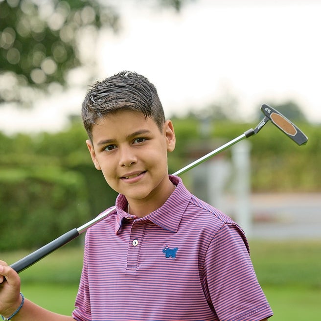 Young Golf Classic participant holding club