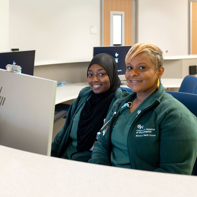 Two staff members at a check-in desk