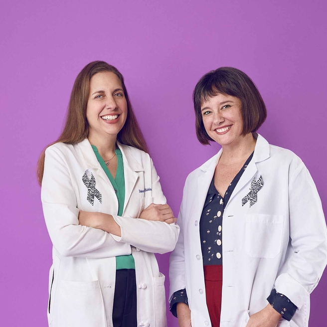 Two physician-researchers smiling.