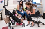 Alexa, 4, and her mother, Alejandra, meet with McKenzie in the Seating Clinic. Alexa’s genetic condition has weakened her legs. She is being fitted for a wheelchair so she can learn to propel herself.