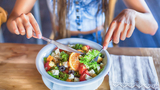 young woman eating salad