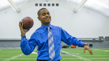 Anthony posing with a football