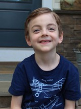 Carter smiling sitting on porch