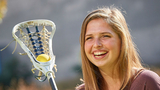 Lucy holding a lacrosse stick