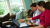 Family on Couch with Laptop Image