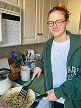 Catherine cooking at the stove