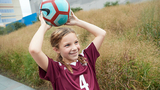 Gabriella holding a soccer ball