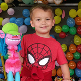 Jeremy at a carnival with a toy