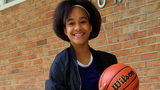 Mariah smiling standing with basketball