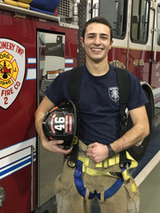 Matthew standing by a fire truck