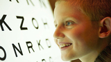 Young boy looking at eye chart