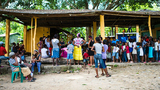 Community members wait for the preventive health activities to begin