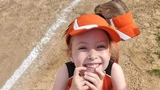 Audrey in her softball uniform