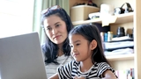 Mother and daughter using computer