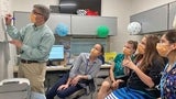 Division chair holding an impromptu teaching session in the fellow workroom