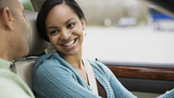 Teen girl driver in car smiling at father