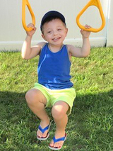 Dean hanging on jungle gym rings