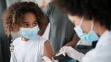 Child getting a vaccine from doctor