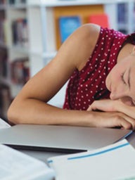 Girl asleep on books