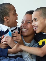 Mom with 2 sons smiling