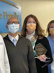 Group photo of CFDT team holding award