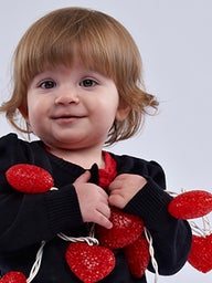 zoey holding hearts on string