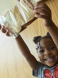 Child holding a sandwich