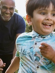 Chasing grandson in the garden during outdoors playtime.