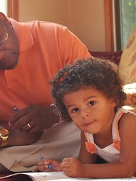 father sitting with young daughter