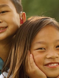 boy hugging girl and smiling