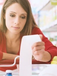 upset woman holding grocery receipt